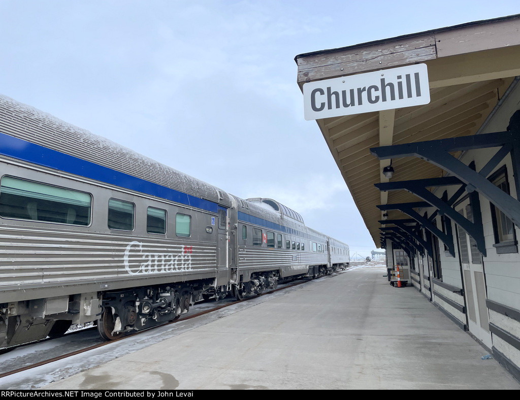 The iconic Churchill Station sign blends in well with the iconic VIA Rail Budd HEP rolling stock 